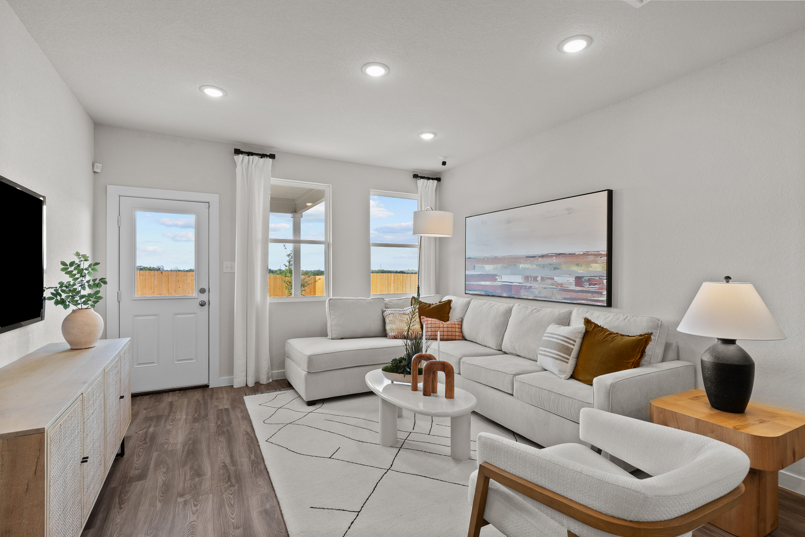 A living room with white furniture.