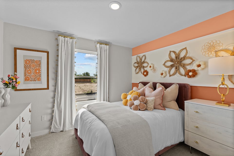 A bedroom with a large window.