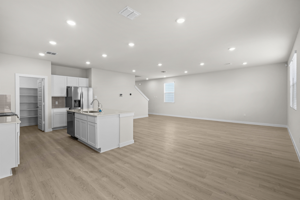A large kitchen with white cabinets.
