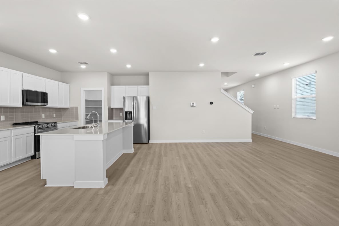 A kitchen with white cabinets.