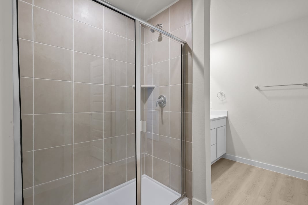 A shower with a glass door.
