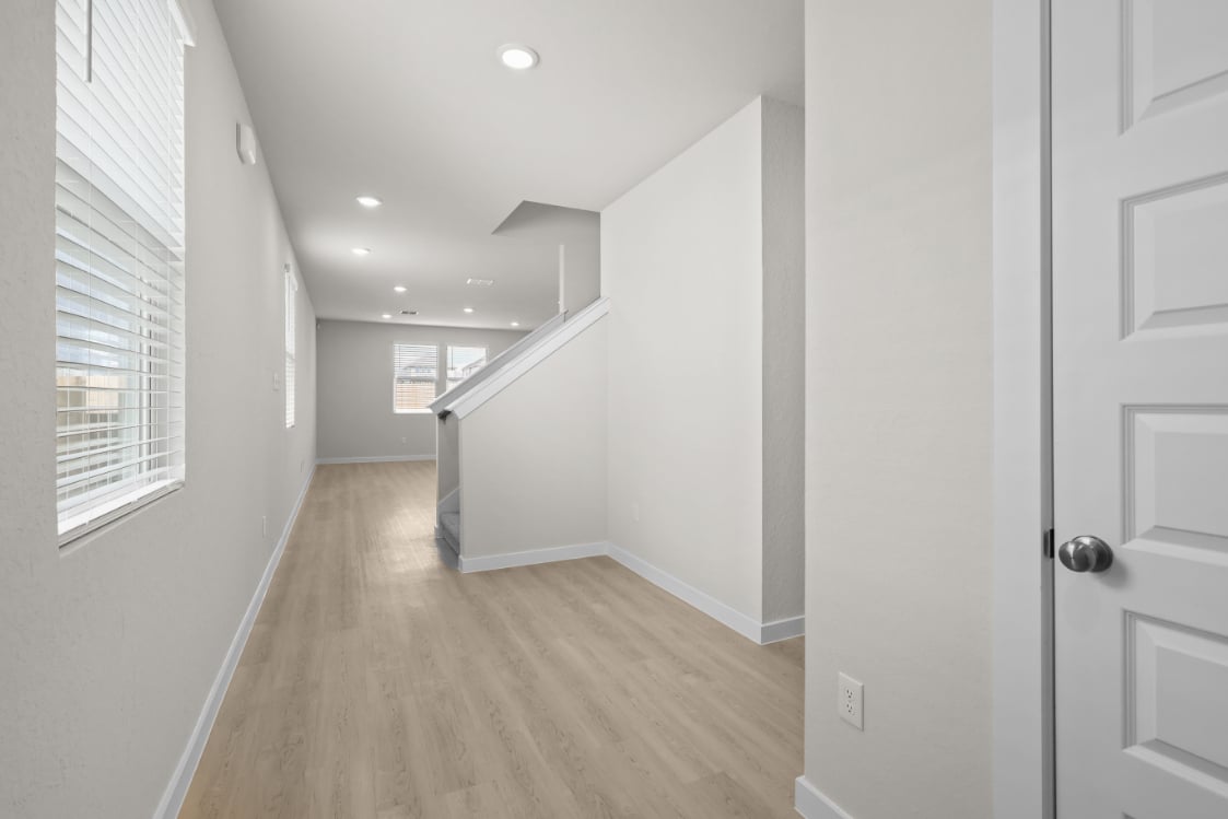 A hallway with white walls.
