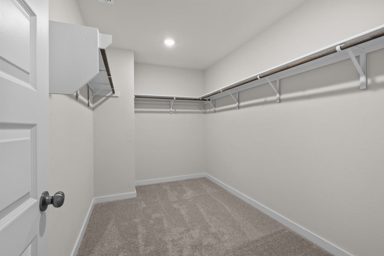 A white room with a metal railing.