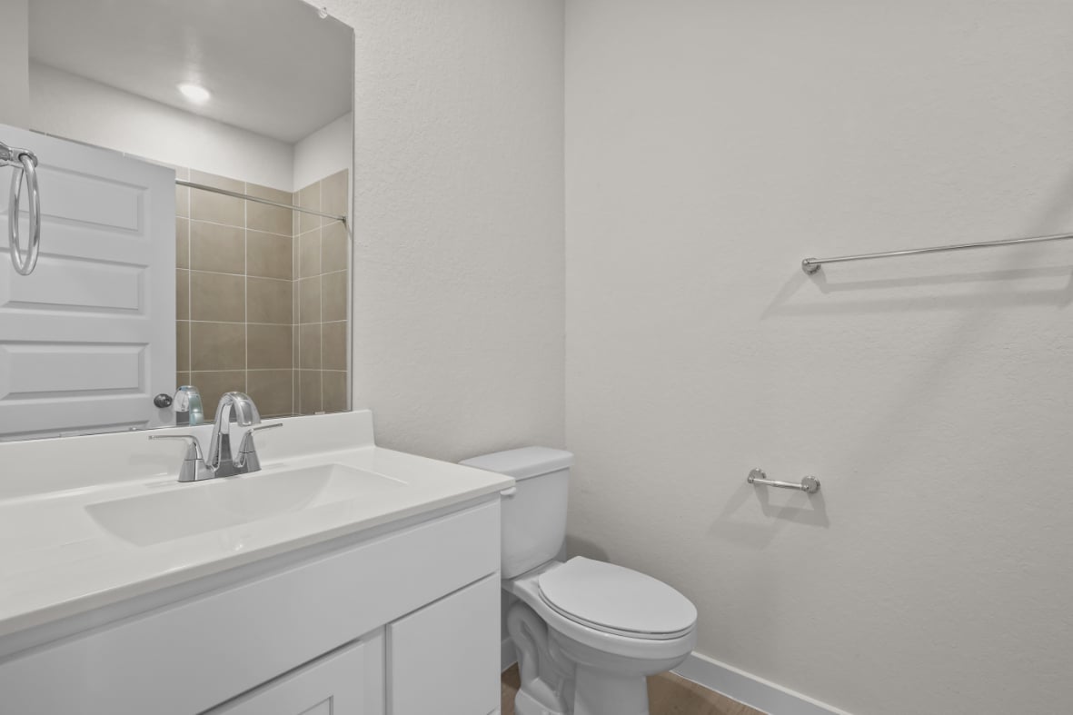 A bathroom with a toilet and sink.