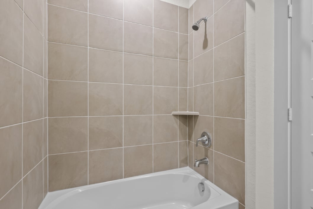 A bathtub in a bathroom.
