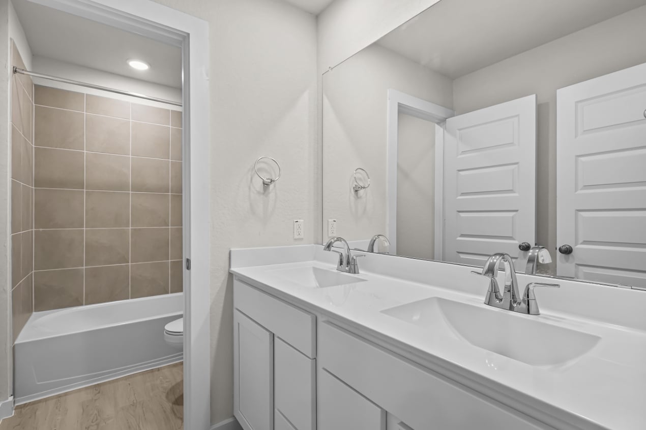 A bathroom with a tub sink and a toilet.