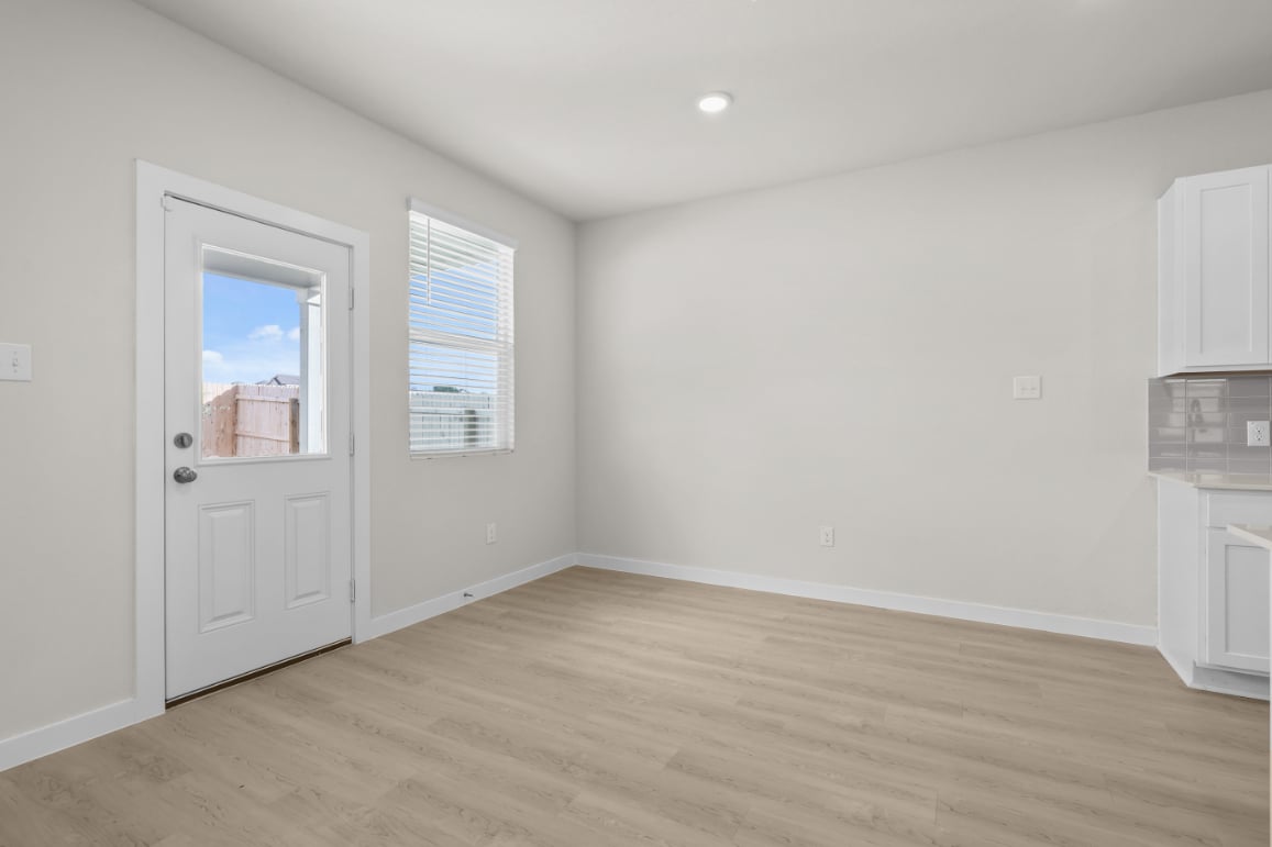 A room with a wood floor and white walls.