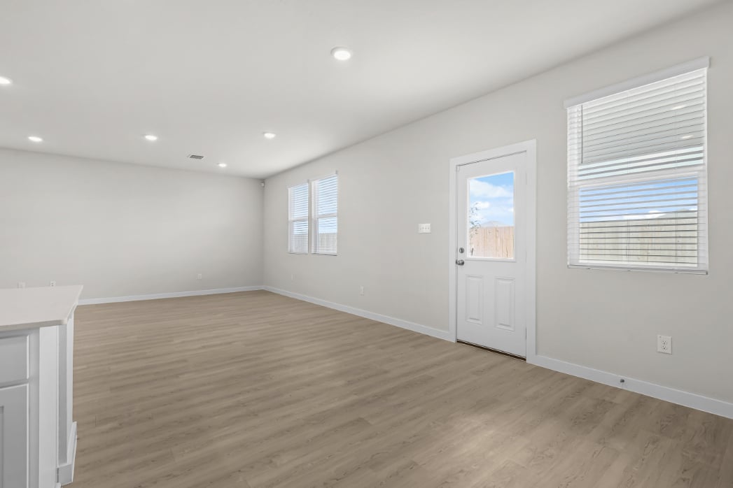 A room with a wood floor and white walls.