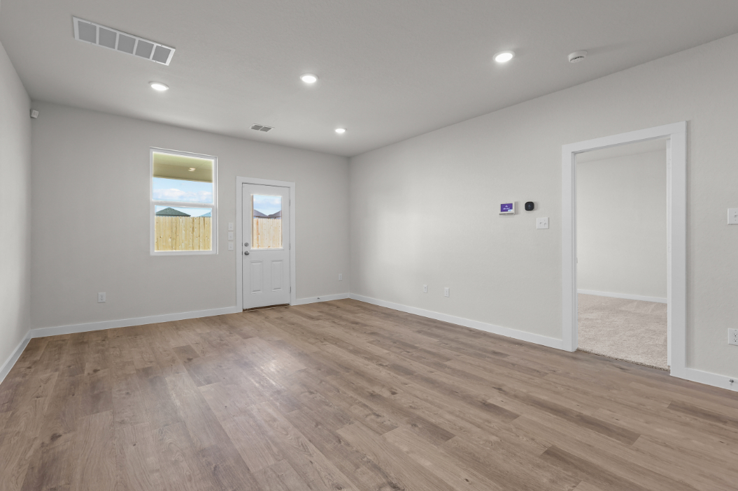 A room with a wood floor and white doors.