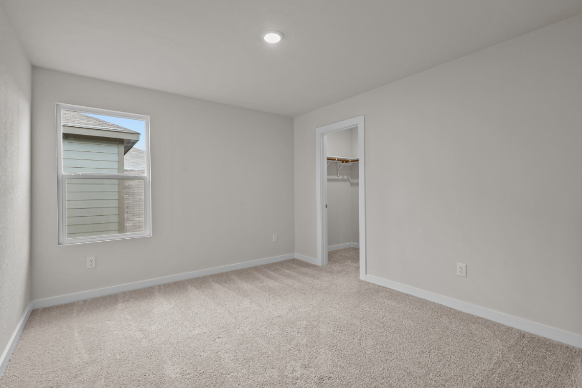 A room with a window and a door.