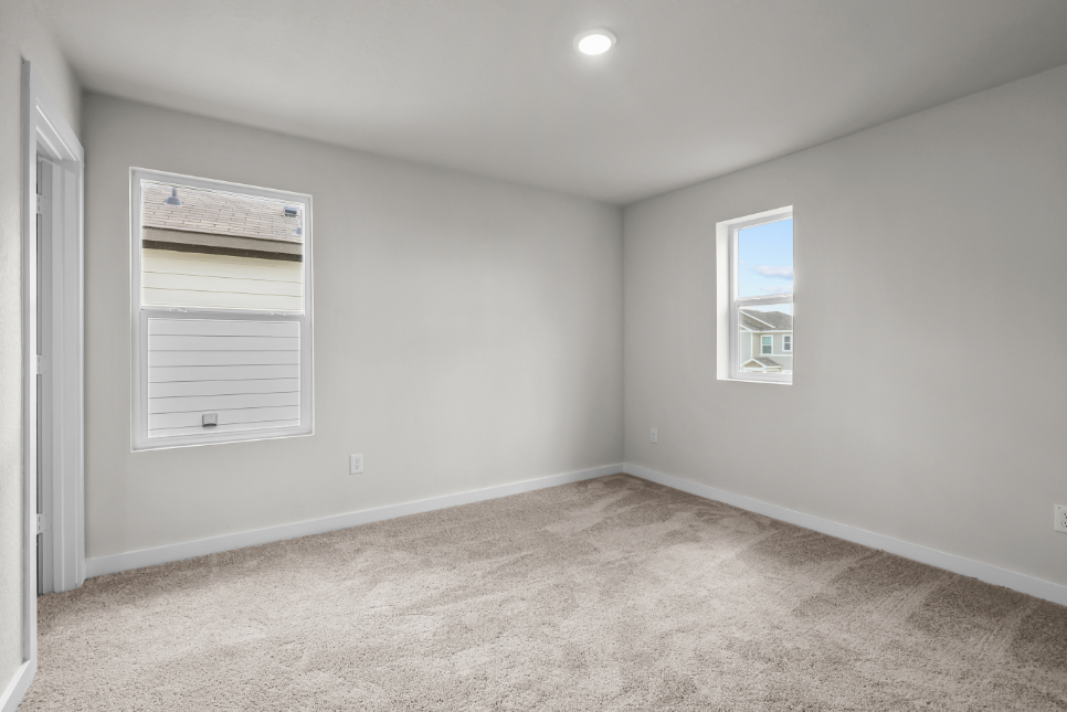 A room with a window and a carpet.