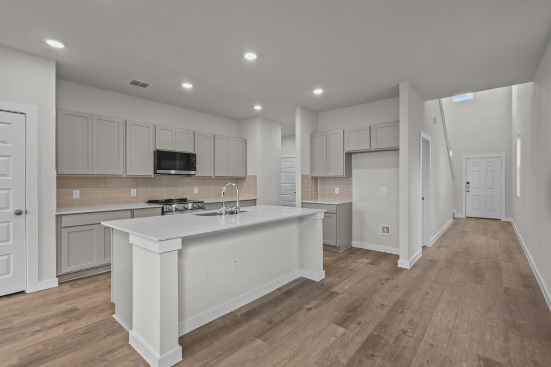 A kitchen with white cabinets.