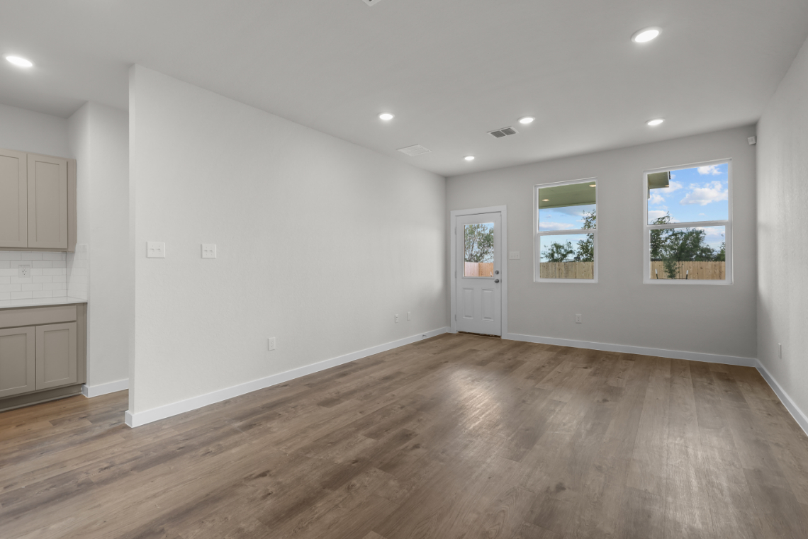 A room with white walls and a wood floor.