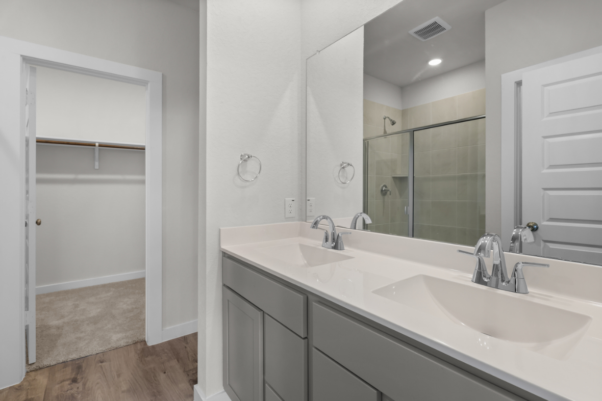 A bathroom with a large mirror.