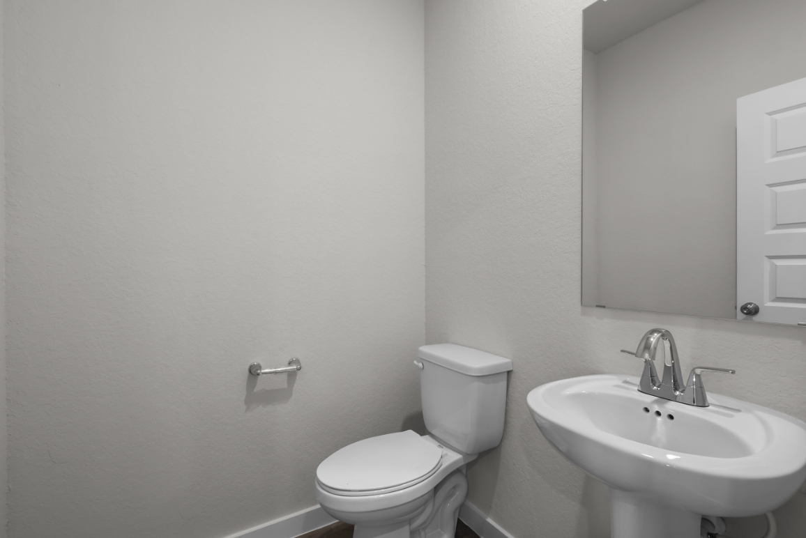 A bathroom with a toilet and sink.