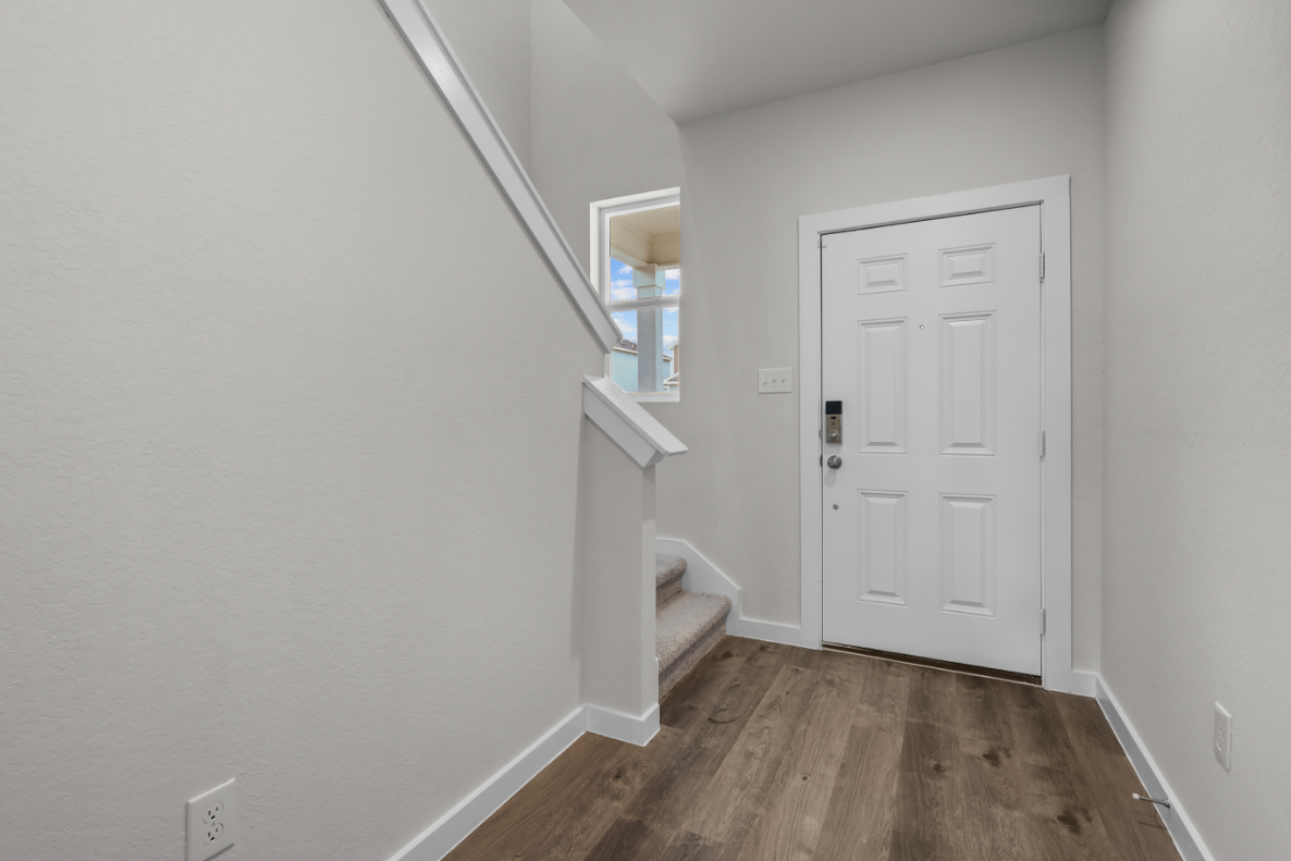 A room with white walls and a wood floor.