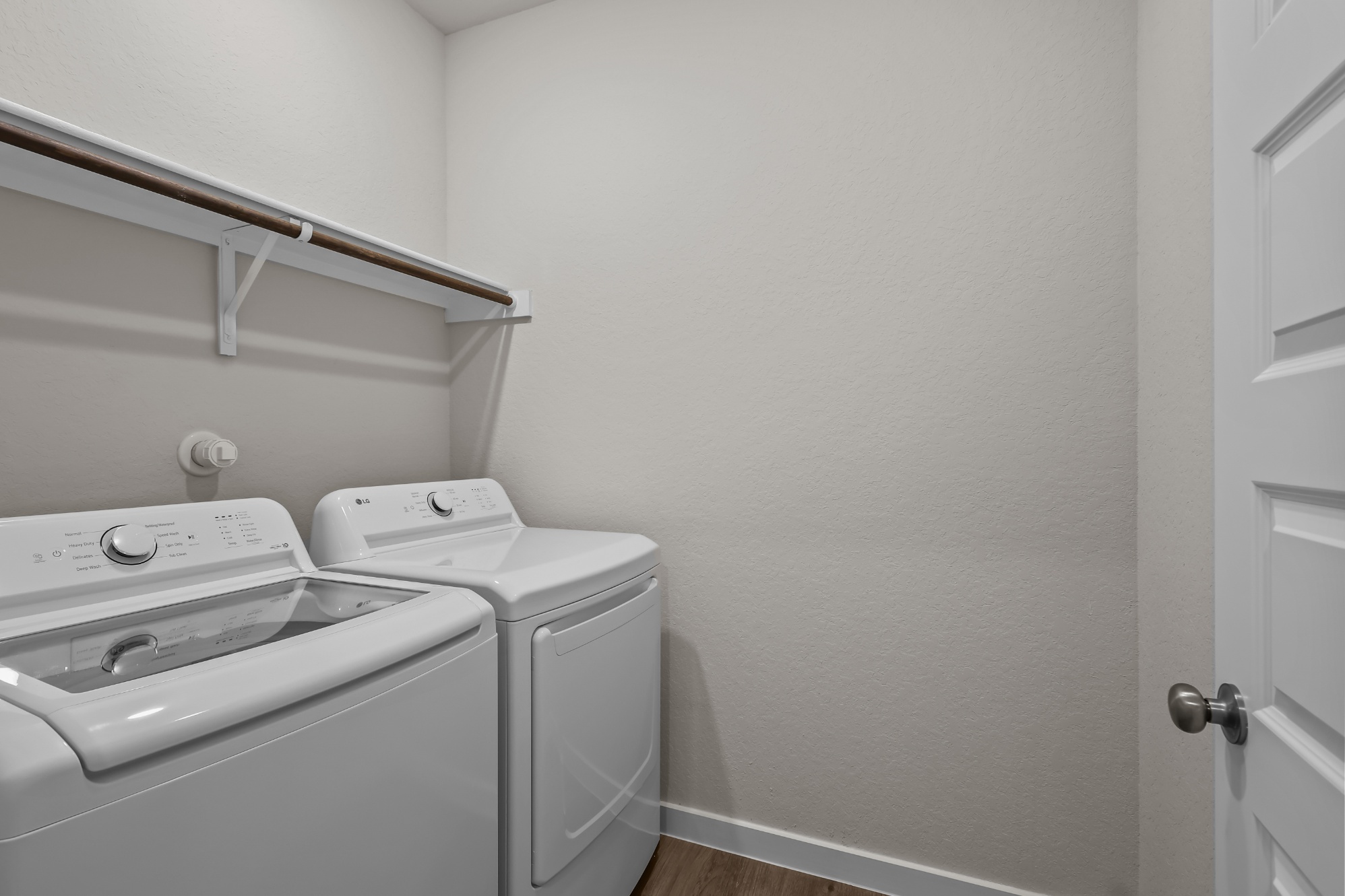 A washing machine and dryer in a room.