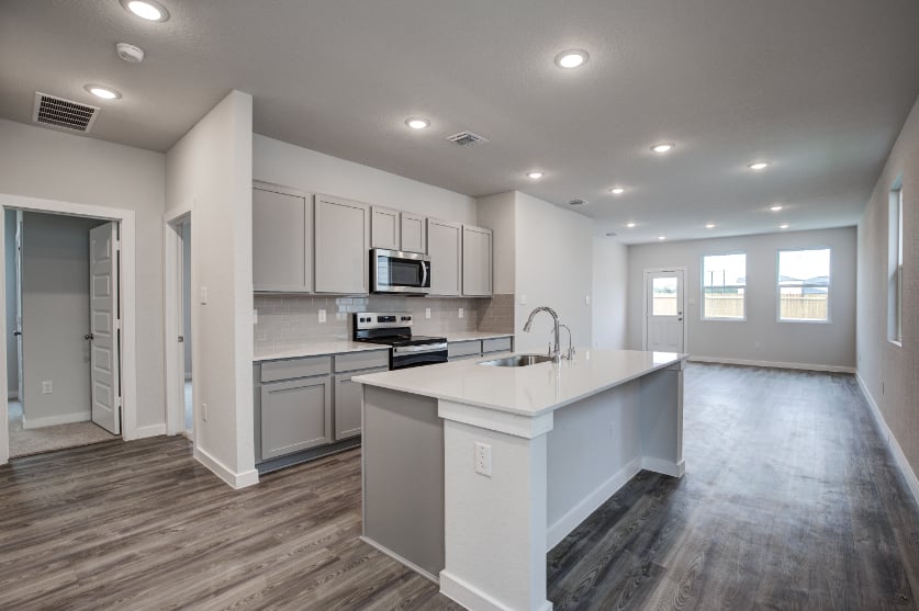 A kitchen with white cabinets.