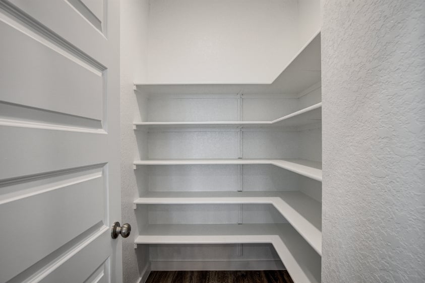 A white shelf with white doors.