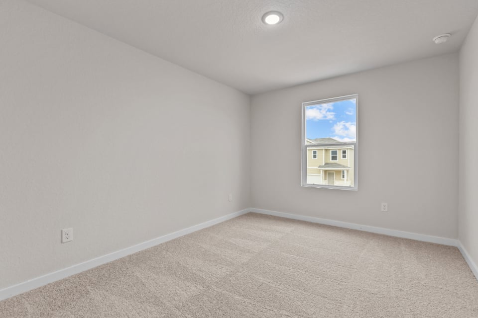 A room with a painting on the wall.