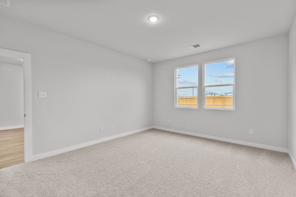 A room with a window and a door.