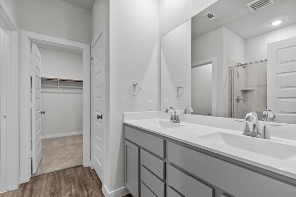 A bathroom with a large mirror.