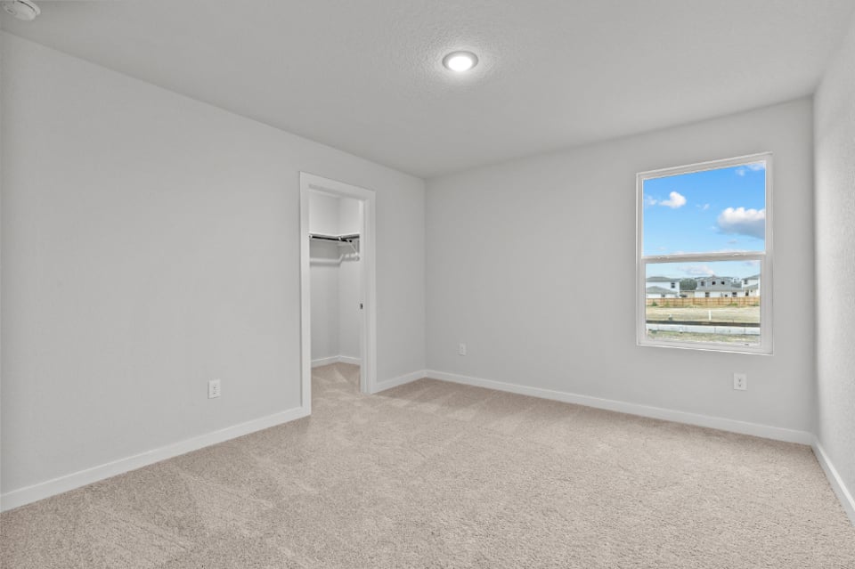 A room with a painting on the wall.