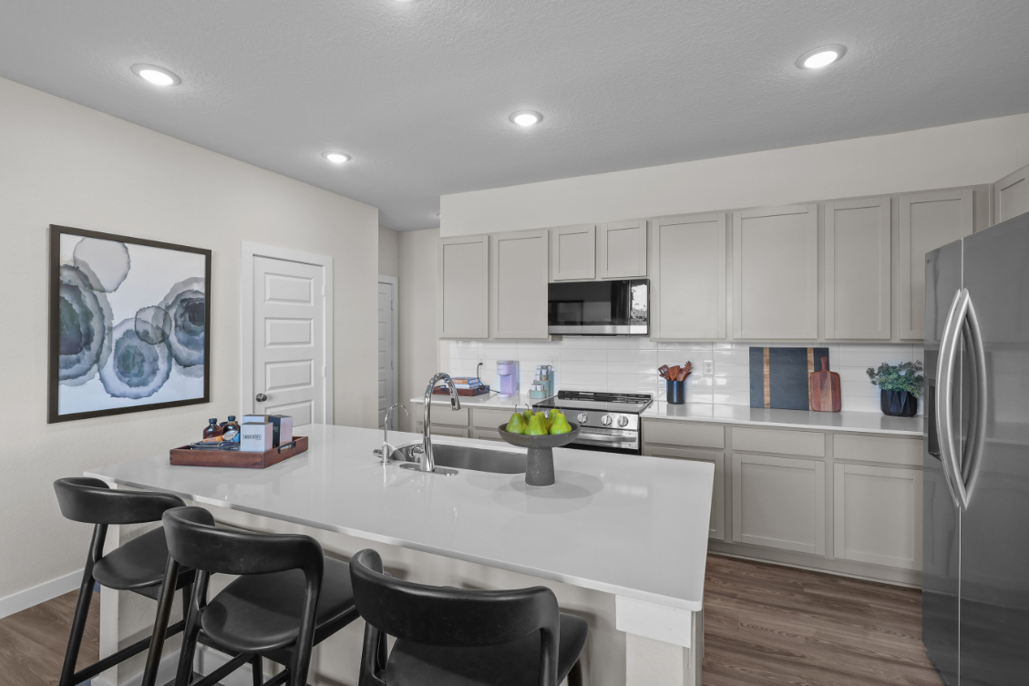 A kitchen with white cabinets.