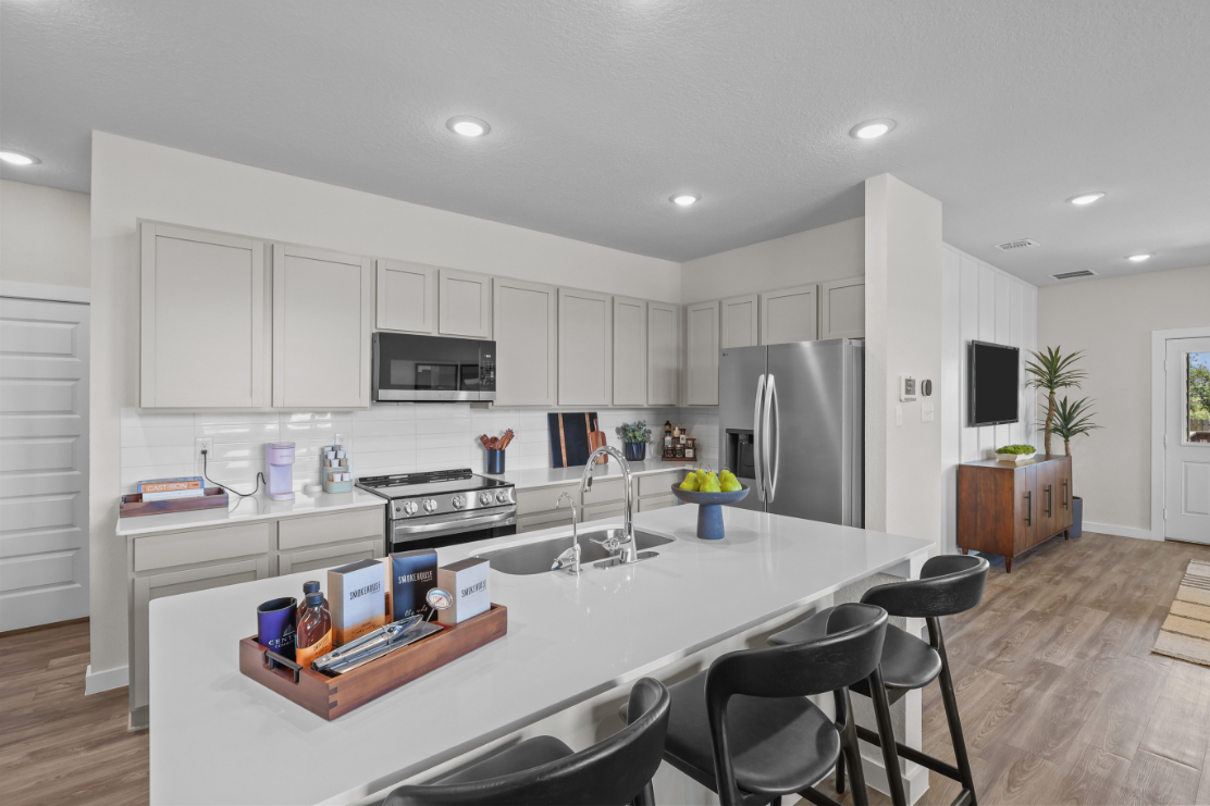 A kitchen with white cabinets.
