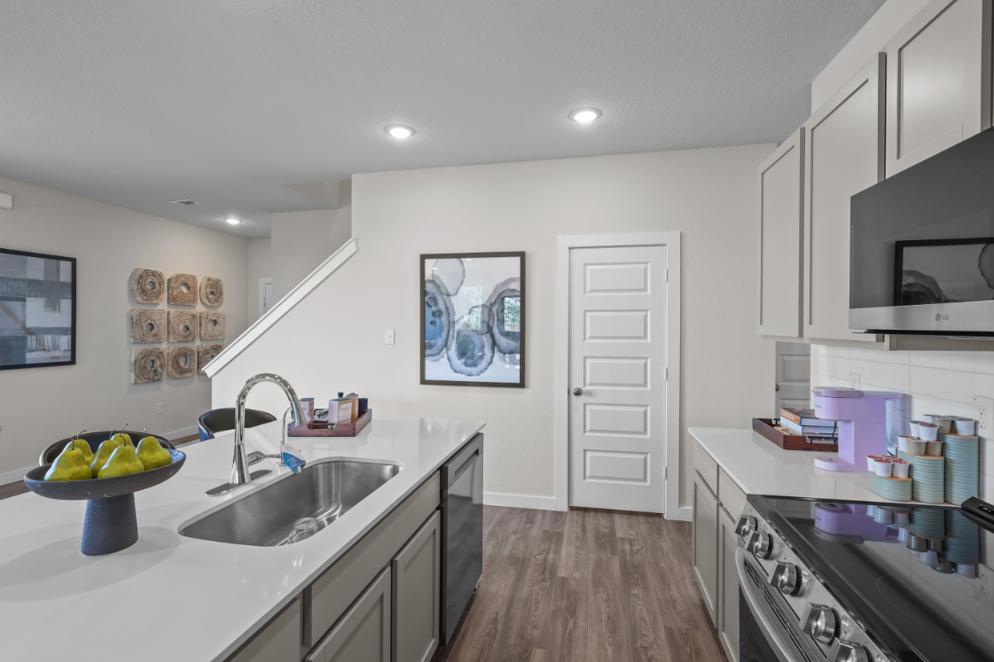 A kitchen with white cabinets.