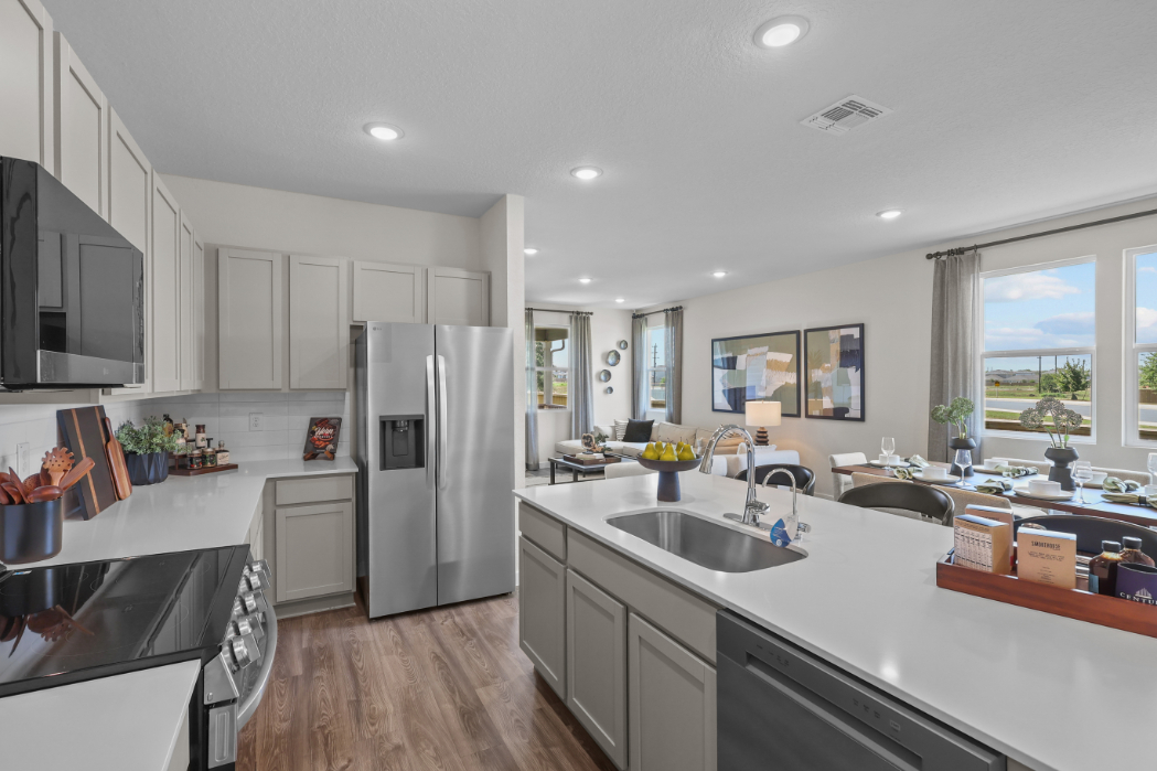 A kitchen with white cabinets.