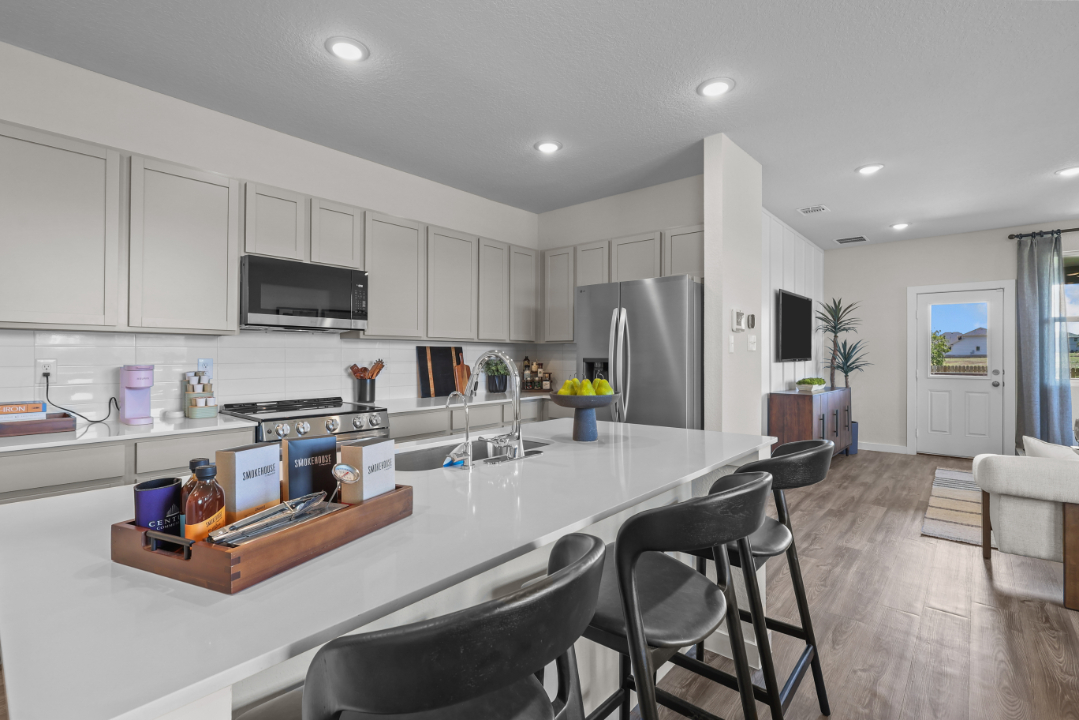A kitchen with white cabinets.