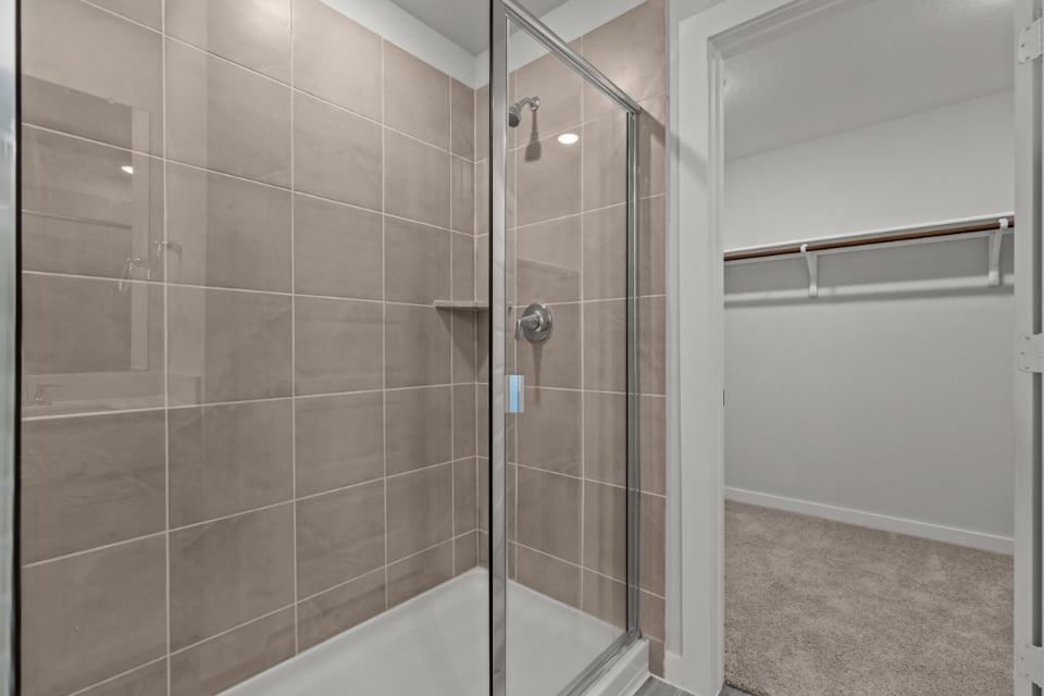 A shower with a glass door.