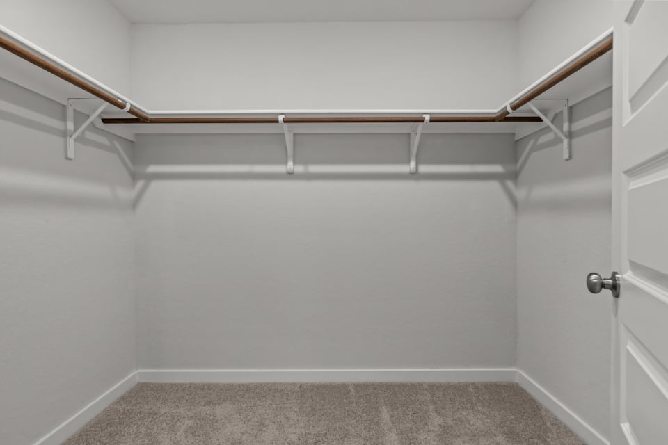 A white wall with a metal bar.