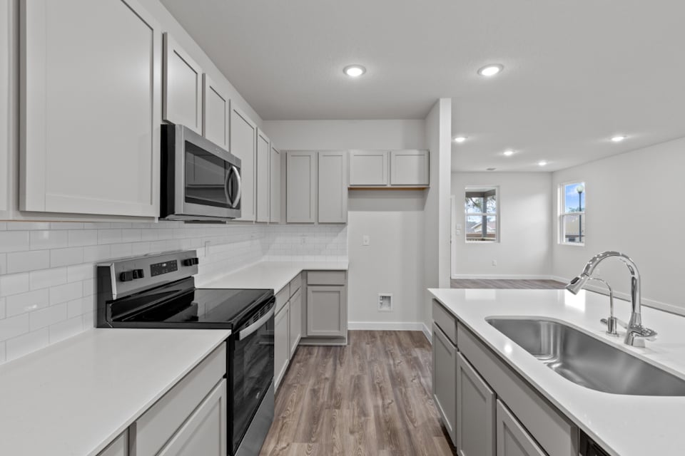 A kitchen with white cabinets.