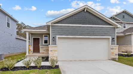 A house with a garage with American Gothic House in the background.