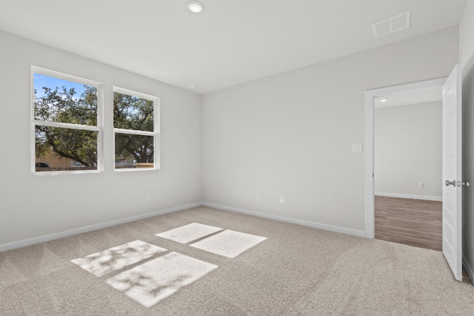 A room with a rug and a door.
