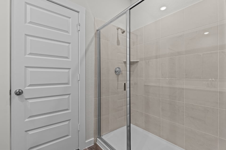 A shower with a glass door.