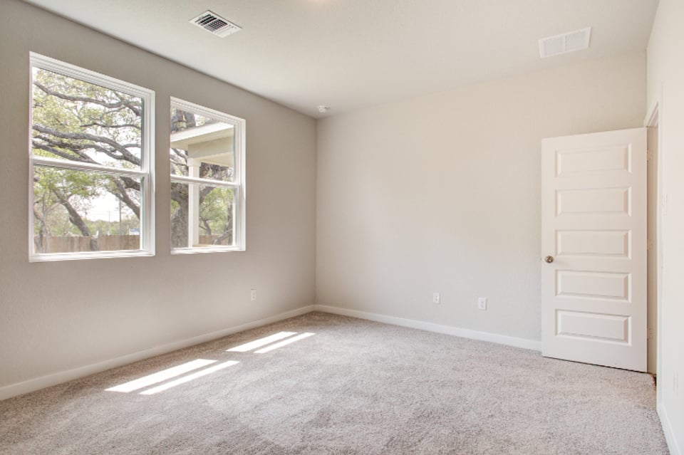 A room with a window and a door.