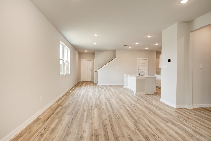 A room with white walls and a wood floor.