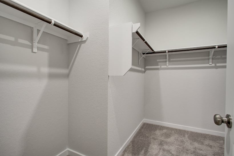 A white wall with a metal bar.