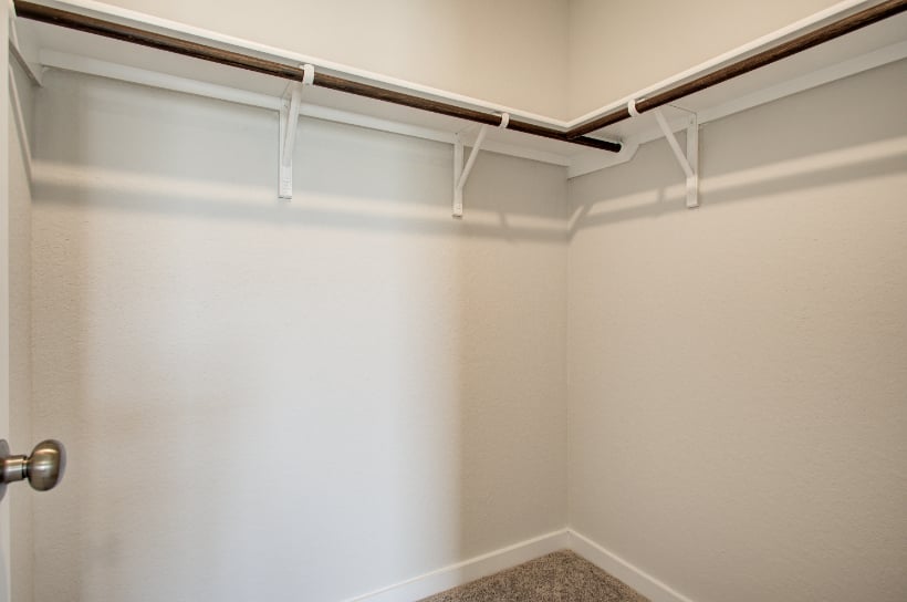 A white wall with a metal railing.