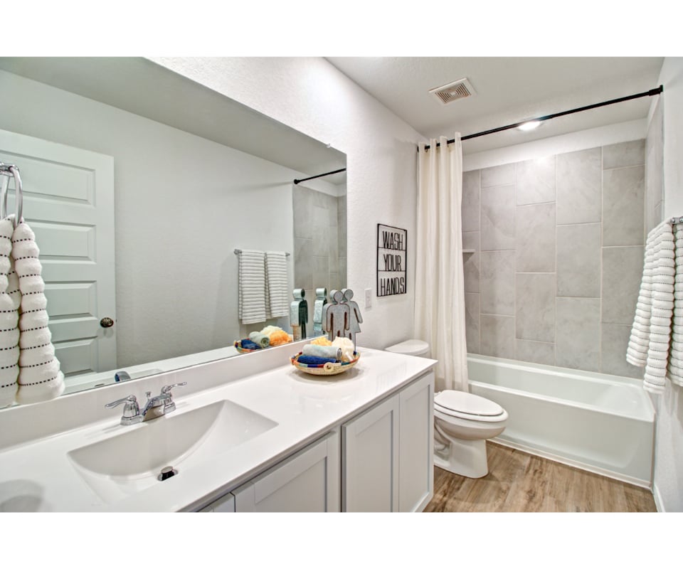 A bathroom with a tub sink and toilet.
