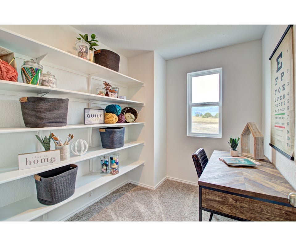 A room with a table and shelves.