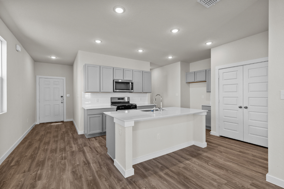 A kitchen with white cabinets.