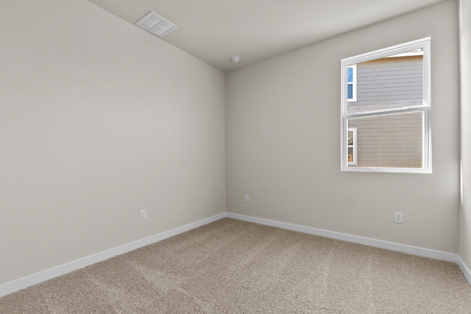 A room with a window and carpet.