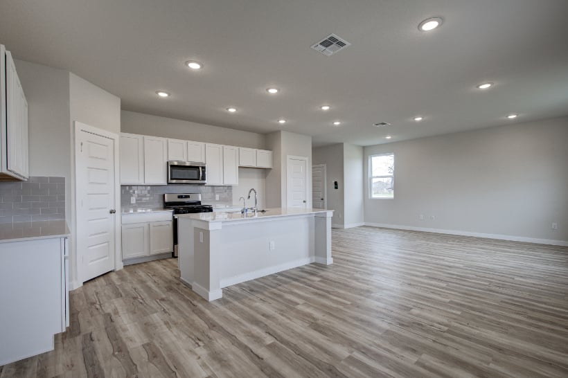 A kitchen with white cabinets.