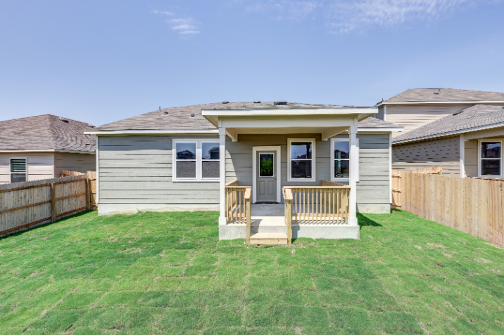 A house with a fence and grass.