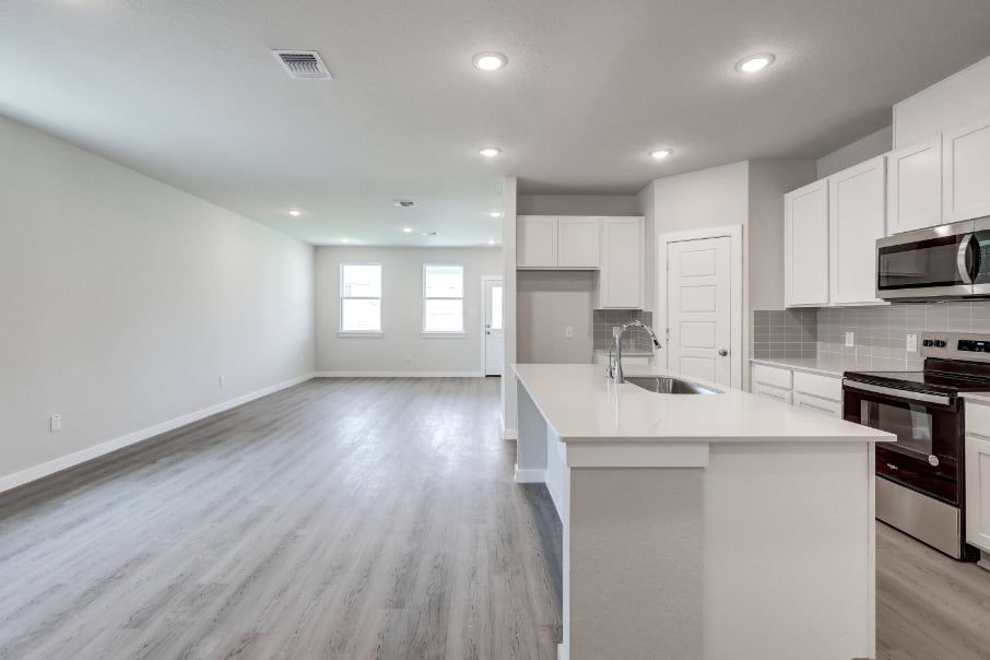 A kitchen with white cabinets.