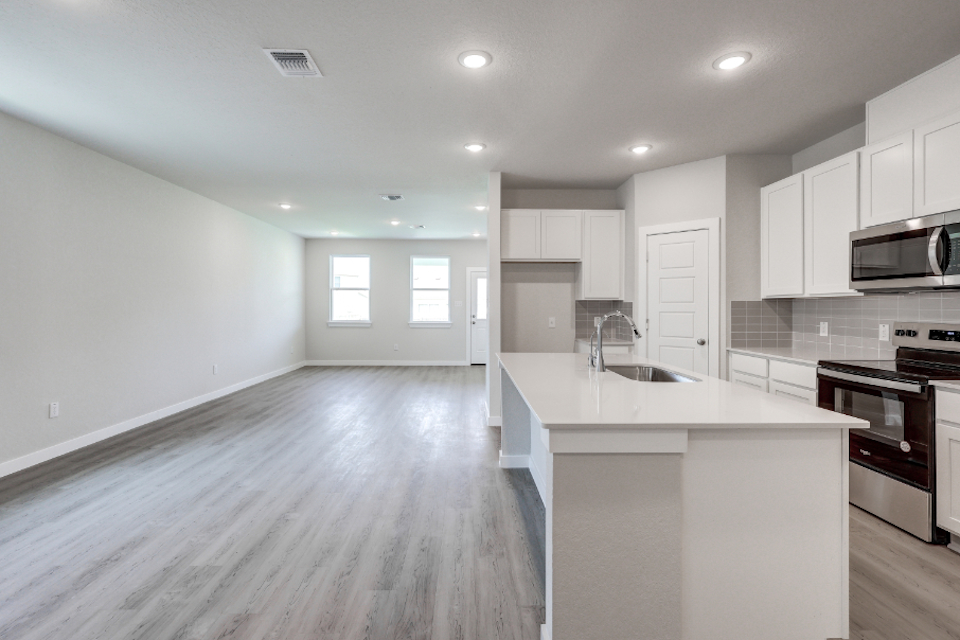 A kitchen with white cabinets.